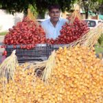 A vendor displaying raw dates to attract the customers at his roadside setup