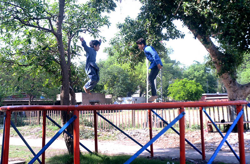 Children enjoying jumping on trampoline at vendors’ roadside setup