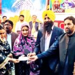 Provincial Minister Minority Affairs Sardar Ramesh Singh Arora and Deputy Speaker Punjab Assembly Malik Zaheer Iqbal Chand is distributing relief checks to minority women in a ceremony organized on the occasion of Easter and Holi