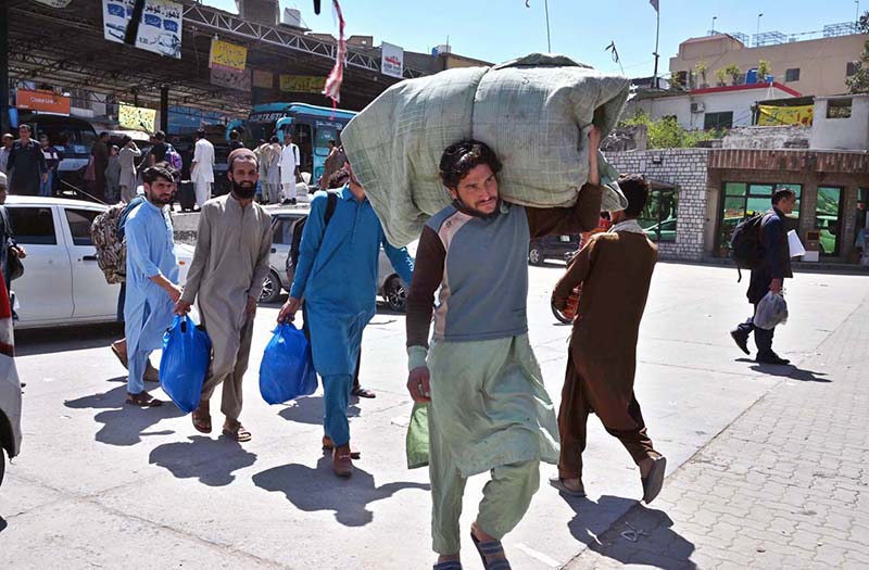 People arrives at Faizabad Bus Stand to travel their hometowns to celebrate Eid ul Fitr with their loved ones