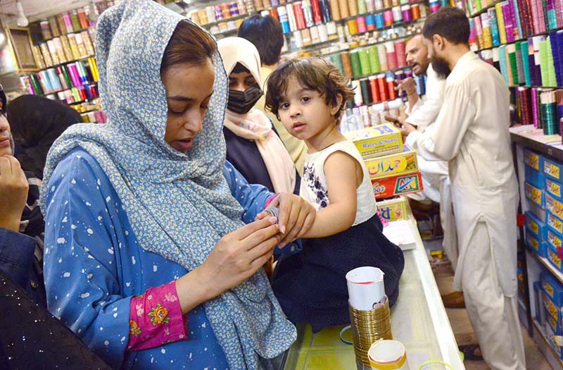 People busy in Eidul Fitr shopping at a market in the city