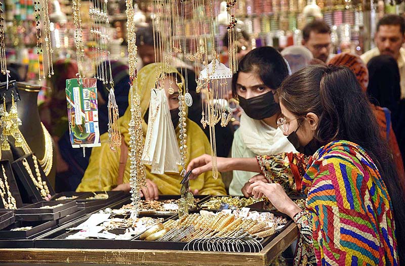 Women selecting and purchasing artificial jewelry in preparation of Eid-ul-Fitr.