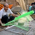 A street vendor making room cooler net at roadside