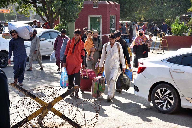 People along with their luggage arrives at Railway Station to leave for their hometowns to celebrate Eid-ul-Fitr with their loved ones