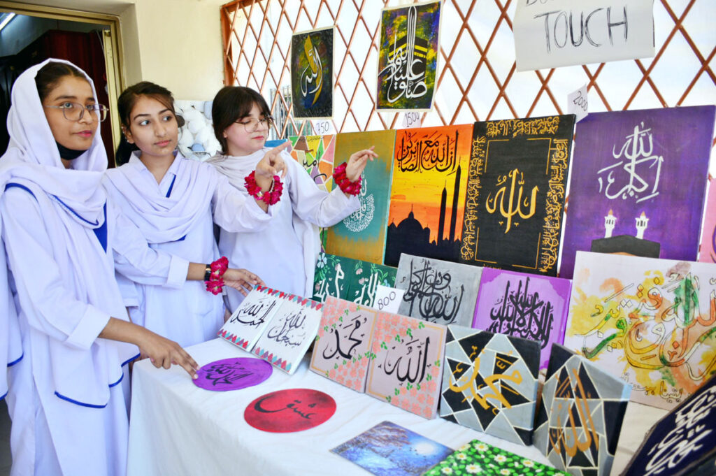 Students purchasing artificial jewelry from stall during Eid Festival at Shah Latif Girl College.