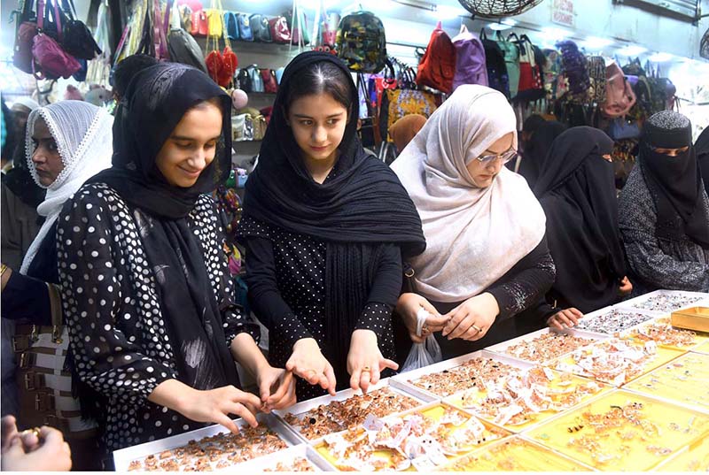 Women purchasing artificial jewelry ahead of Eid-ul-Fitr at Hyderi Market