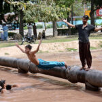 Youngsters diving in canal for swimming to get relief in hot weather in city