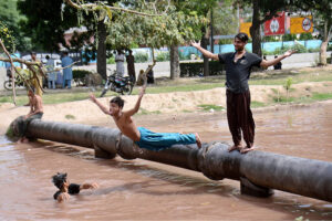 Youngsters diving in canal for swimming to get relief in hot weather in city