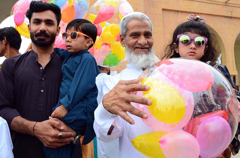 Children purchasing balloons from a vendor outside Eidgah on the occasion of Eidul Fitr