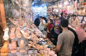 A shopkeeper is attracting customers in the upcoming Eid-ul-Fitr by showcasing women's favorite artificial jewelry products.