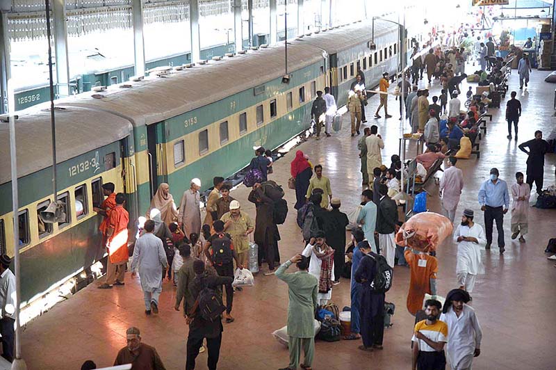 People along with their luggage arrives at Railway Station to leave for their hometowns to celebrate Eid-ul-Fitr with their loved ones