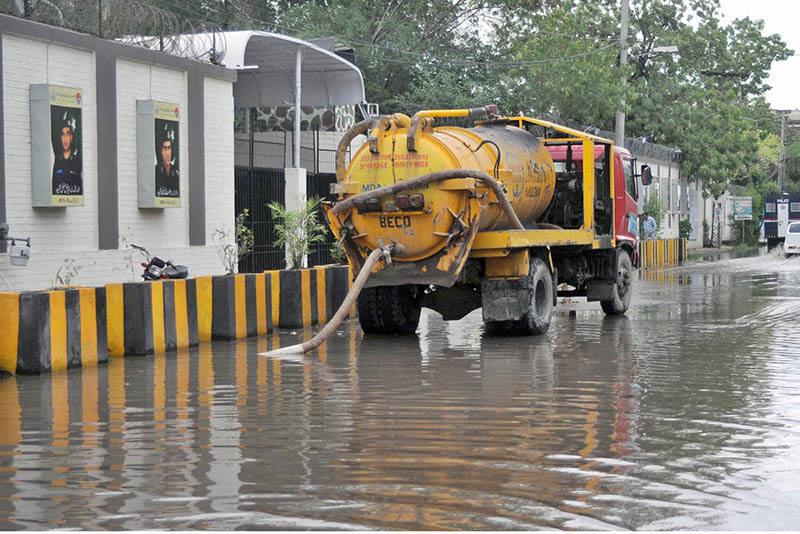WASA heavy machinery being used for the drainage of rainwater in front of the main gate of the Police Line after rain in the city