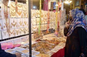 A shopkeeper is attracting customers in the upcoming Eid-ul-Fitr by showcasing women's favorite artificial jewelry products.