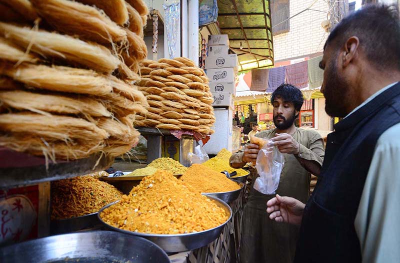 Vendor selling and displaying traditional food items to attract the customers here in the Hashtnagri area