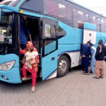 Families arriving back from their home town after Eid-ul-Fitr celebrations at Fiazabad Bus Stand.