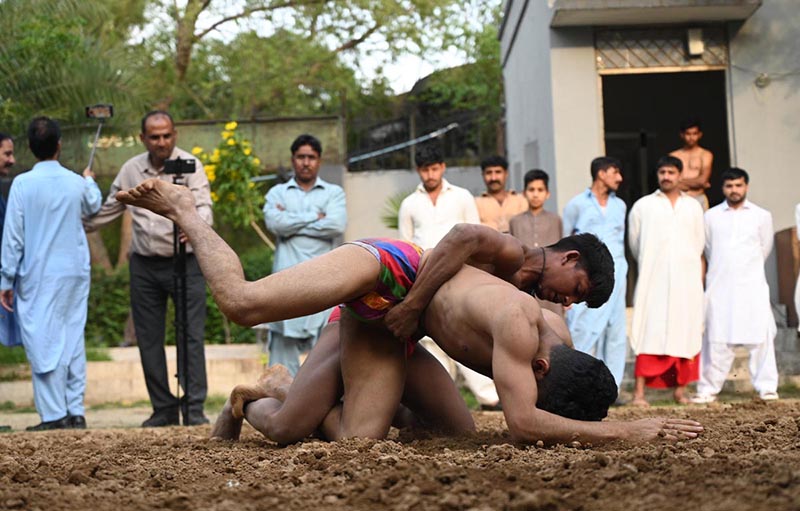 Pakistani wrestlers showcase their skills at the century-old Akhara during the annual spring wrestling competition at Liaqat Bagh