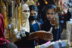 Women selecting and purchasing children sandals in preparation of Eid-ul-Fitr