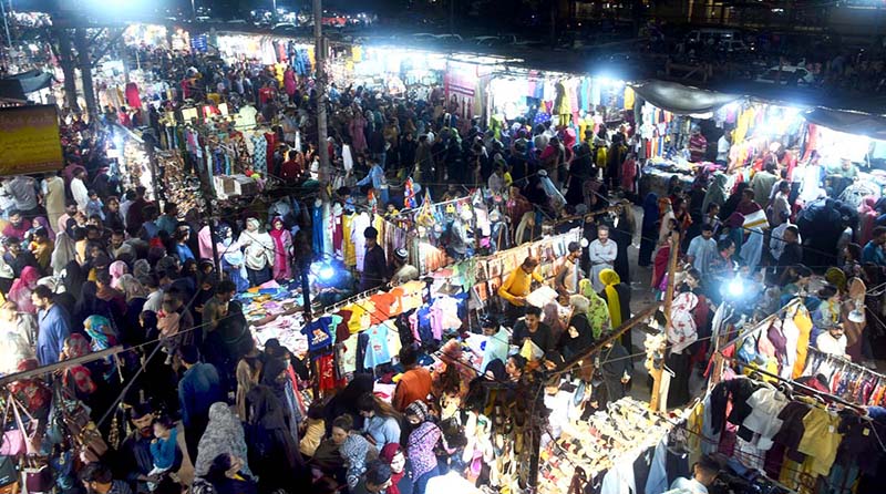 Women purchasing artificial jewelry ahead of Eid-ul-Fitr at Hyderi Market