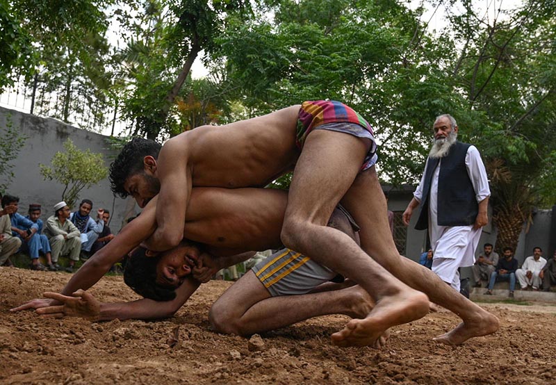 Pakistani wrestlers showcase their skills at the century-old Akhara during the annual spring wrestling competition at Liaqat Bagh