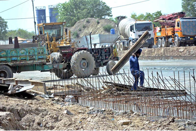Laborers are working on construction of a building to earn their livelihood while the world celebrates International Labor Day.