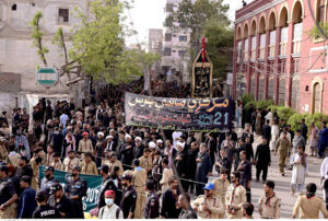 Shia Muslim attending mourning procession on Yom-e-Shahadat at Dadan Shah Road.
