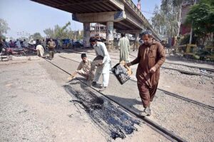 Railway workers are busy in repairing railway track near Railway station phatak.