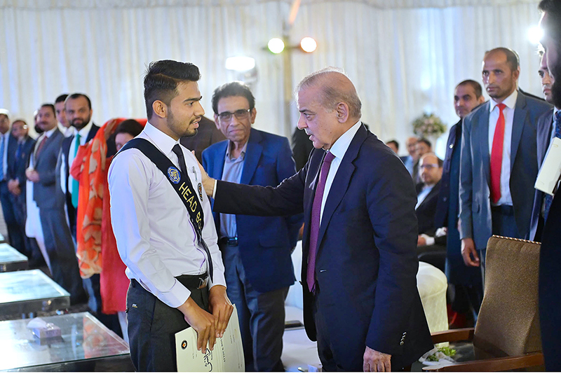 Prime Minister Muhammad Shehbaz Sharif meets a student of Danish School, Jand, Attock in the ceremony at the proposed site of Danish School