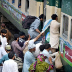 People boarding on train at Railway Station to leave for their hometowns to celebrate Eid-ul-Fitr with their loved ones