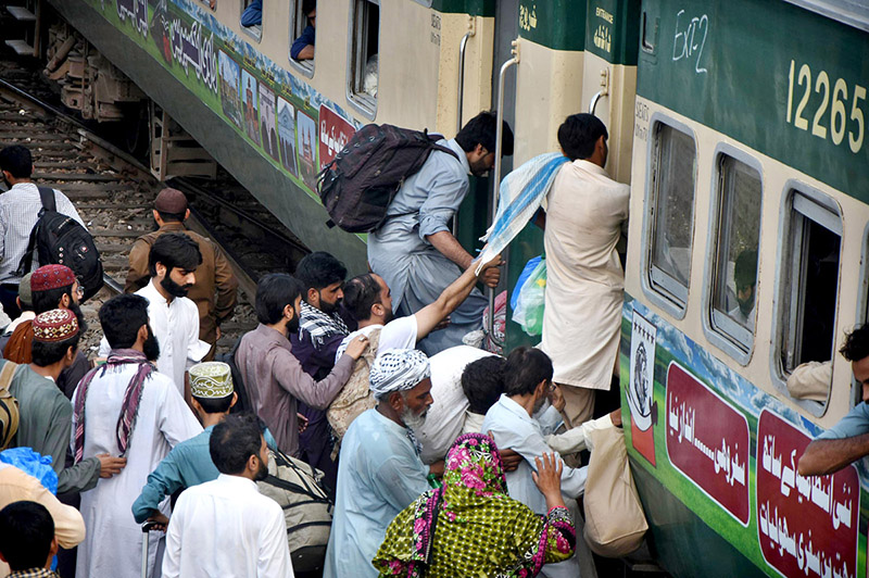 People boarding on train at Railway Station to leave for their hometowns to celebrate Eid-ul-Fitr with their loved ones