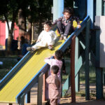 Children having fun by taking slides at Frere Hall