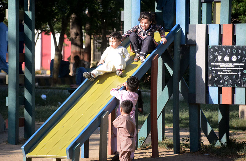 Children having fun by taking slides at Frere Hall