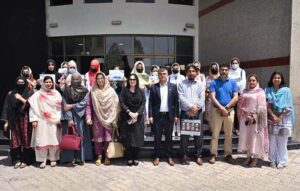 SBBWU students displaying Eco friendly practices and sustainable climate change initiatives charts on a wall during their visit at Trans Peshawar Headquarter.