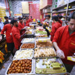 People purchasing traditional sweets from a sweet shop