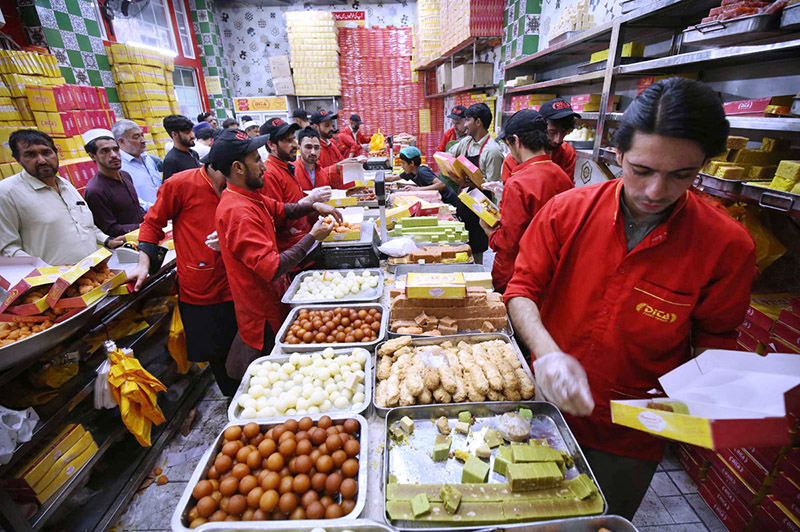 People purchasing traditional sweets from a sweet shop