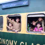 Children waving hands after getting board on Eid Special Train at Cantt Railway Station, departing to their home towns for celebrating Eidul Fitr, festive