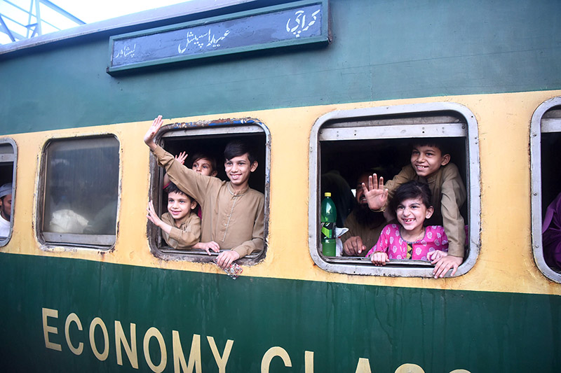 Children waving hands after getting board on Eid Special Train at Cantt Railway Station, departing to their home towns for celebrating Eidul Fitr, festive