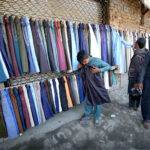 Vendor displayed man's clothes to attract the customers at railway track side setup in Ferdos area