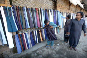 Vendor displayed man's clothes to attract the customers at railway track side setup in Ferdos area
