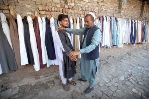 Vendor displayed man's clothes to attract the customers at railway track side setup in Ferdos area