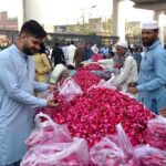 Vendors displaying flowers as a large number of people visit graveyards on Eidul Fitr to offer Fateha on graves of their family members