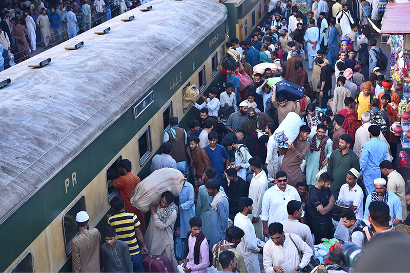 Children waving hands after getting board on Eid Special Train at Cantt Railway Station, departing to their home towns for celebrating Eidul Fitr, festive