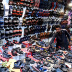A person selecting shoes in last day of Ramadan in preparation of Eidul Fitr at Reshamgali