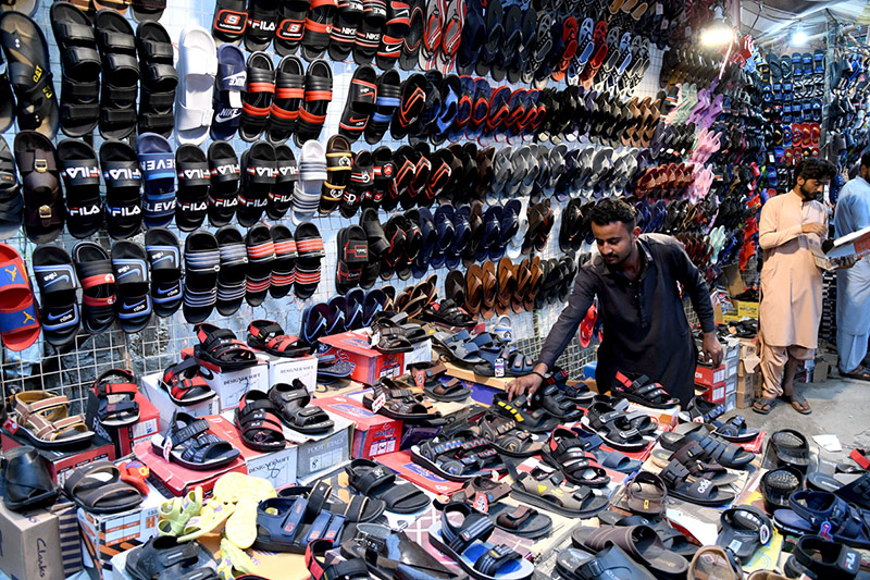 A person selecting shoes in last day of Ramadan in preparation of Eidul Fitr at Reshamgali