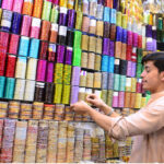 Vendor decorating colorful bangles to attract customers at Churi streets ahead of Eidul Fitr