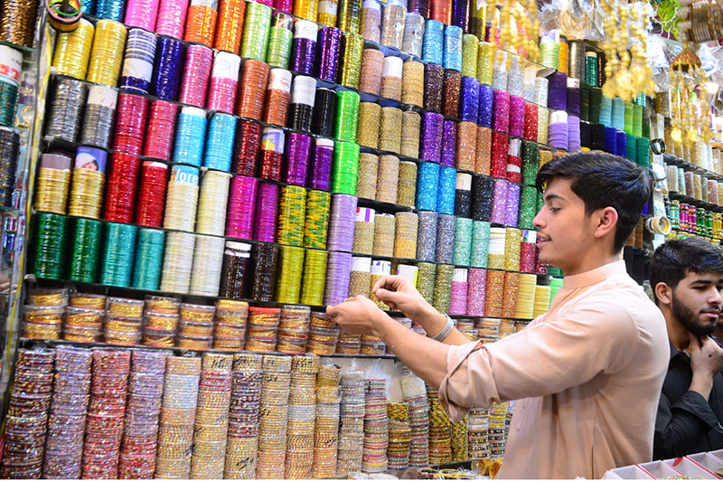 Vendor decorating colorful bangles to attract customers at Churi streets ahead of Eidul Fitr