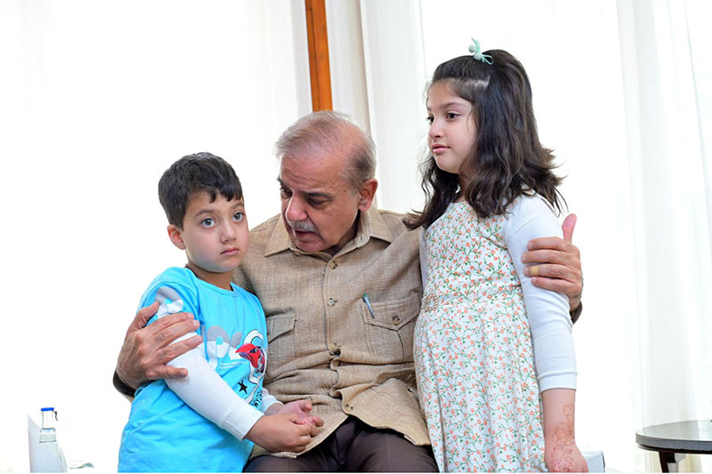 Prime Minister Muhammad Shehbaz Sharif interacts with the children of Customs Inspector Shaheed Husnain Ali Tirmazi.