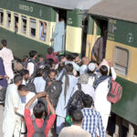 A large number of people getting board on Train at Railway Station departing to their home towns to celebrate Eidul Fitr festive with their loved ones