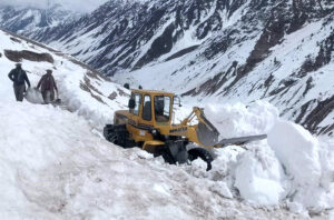 Gilgit-Baltistan Disaster Management Authority workers removing snow from the road and clearing road for vehicles in the valley.