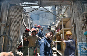 Rescue workers and volunteers are actively engaged in rescue efforts following a gas cylinder explosion at Generator Market.