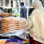 A shopkeeper is setting up a stall of traditional food item before breaking the fast